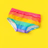 Rainbow-striped kids briefs laid flat on a bright yellow background.